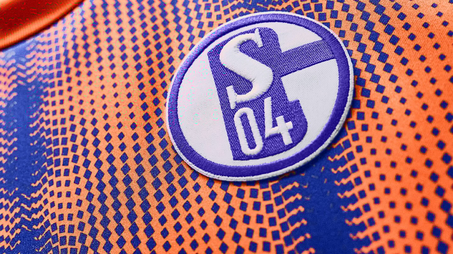 The Schalke logo on the new orange third kit